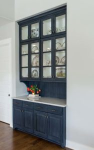 Dark blue glazed cabinet built-ins with white painted insides