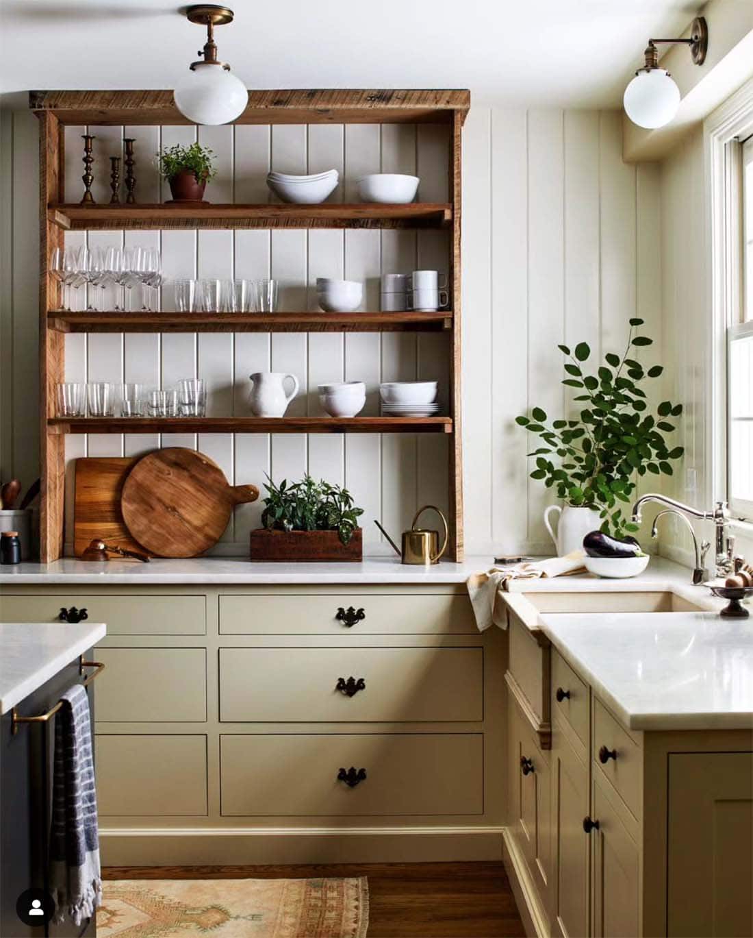 farmhouse-kitchen-with-sage-green-painted-cabinets-and-stained-wood-shelves